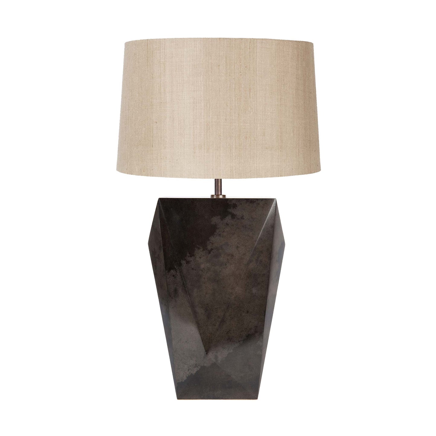 faceted table lamp with a smooth deep charcoal parchment body and a beige tapered linen lampshade