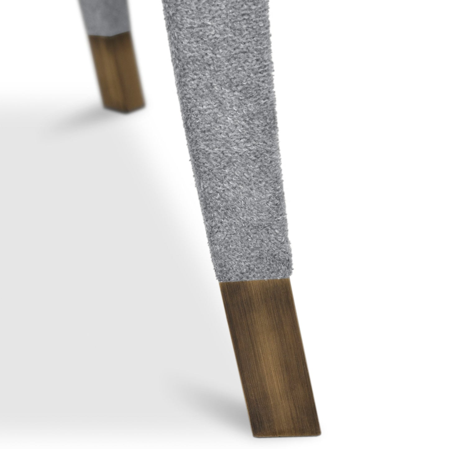 close up image of the dining chair showing the upholstered leg