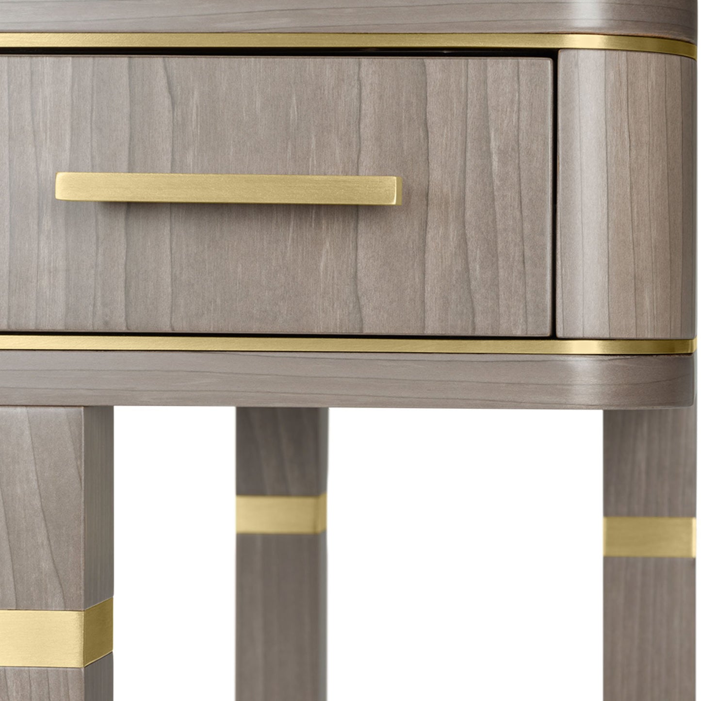 Detail of luxury wood desk with metallic details. The wooden frame with metallic detailing is equipped with ample storage space for all your work accessories, a stylish addition to any work space. Shown here with a satin close pore wood veneer box, drawer fronts and structure and brushed brass details.