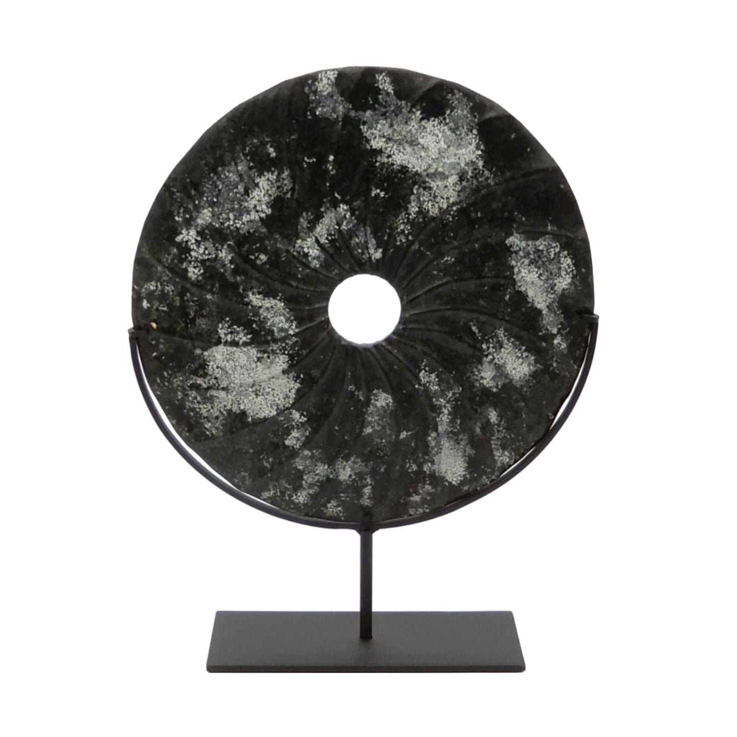 Distressed black marble bi disc with shell type grooves displayed on a bronze stand