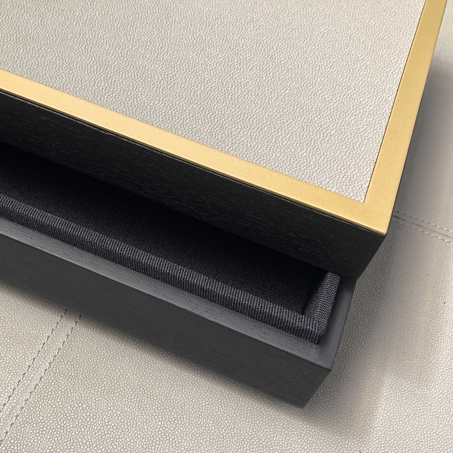 Close up of grey leather covered home decor luxury trinket box with gilt edge..