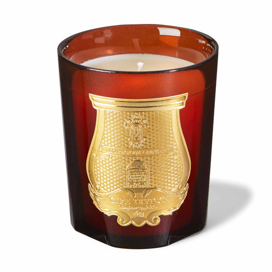 cire trudon candle in a red glass jar with a luxury gold label