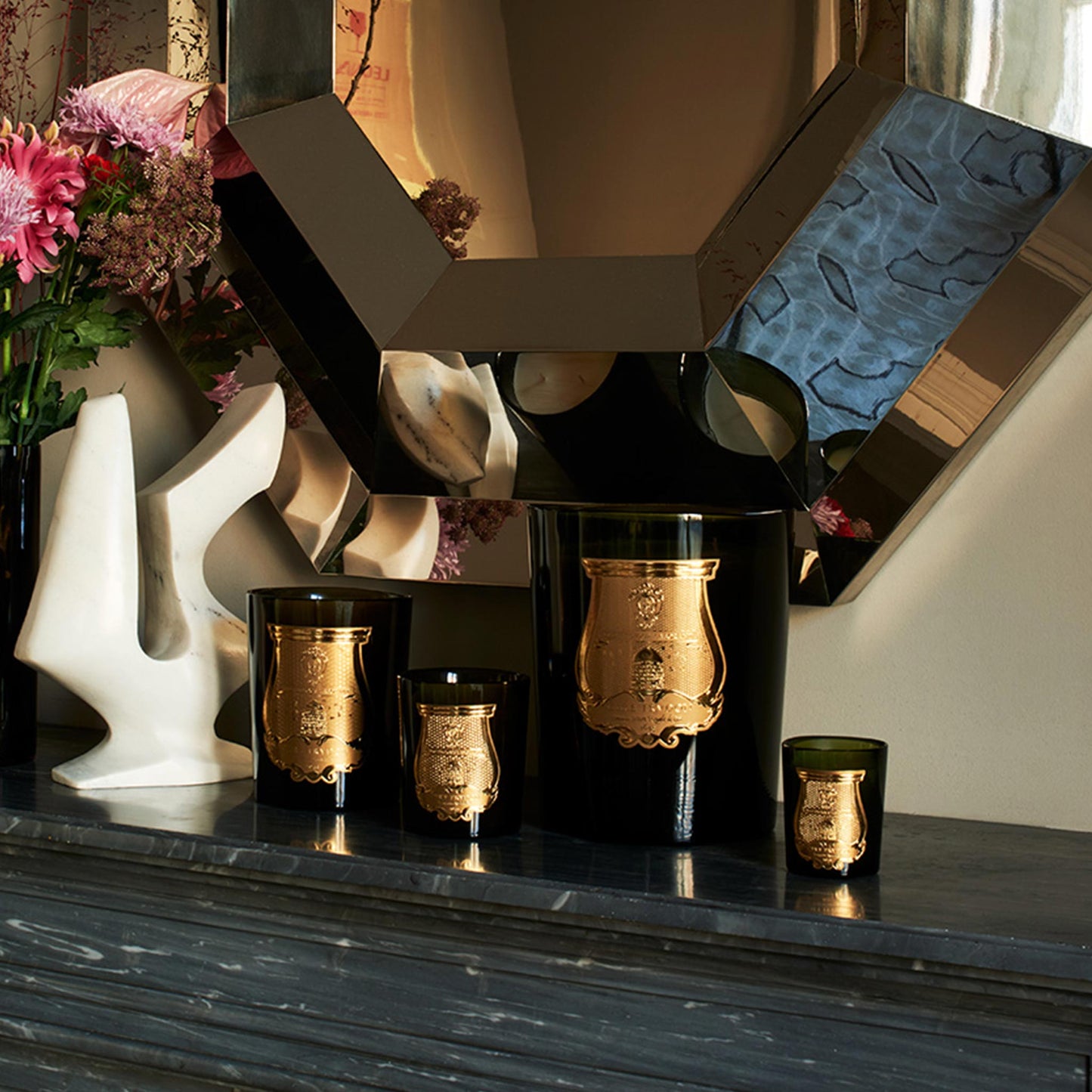 lifestyle image showing the cire trudon candle collection on a side table 