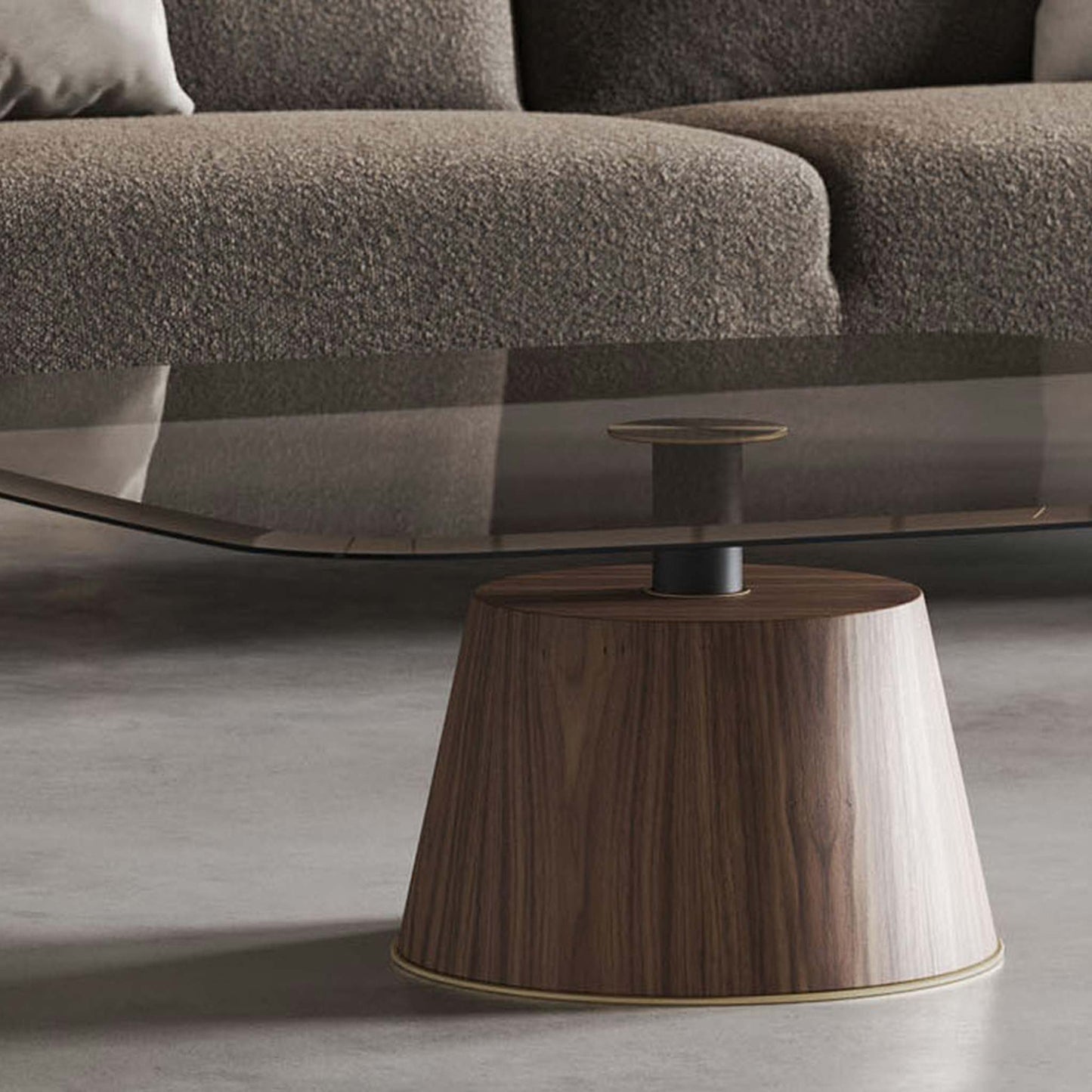 Lifestyle image showing close up of modern smoked glass coffee table on pedestal in modern living room