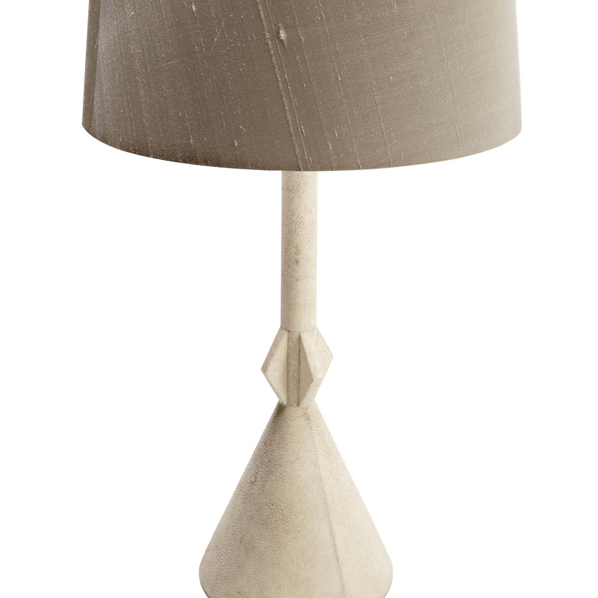 Close up of minimal art deco style pale cream lamp covered in shagreen. Shown with grey silk shade.