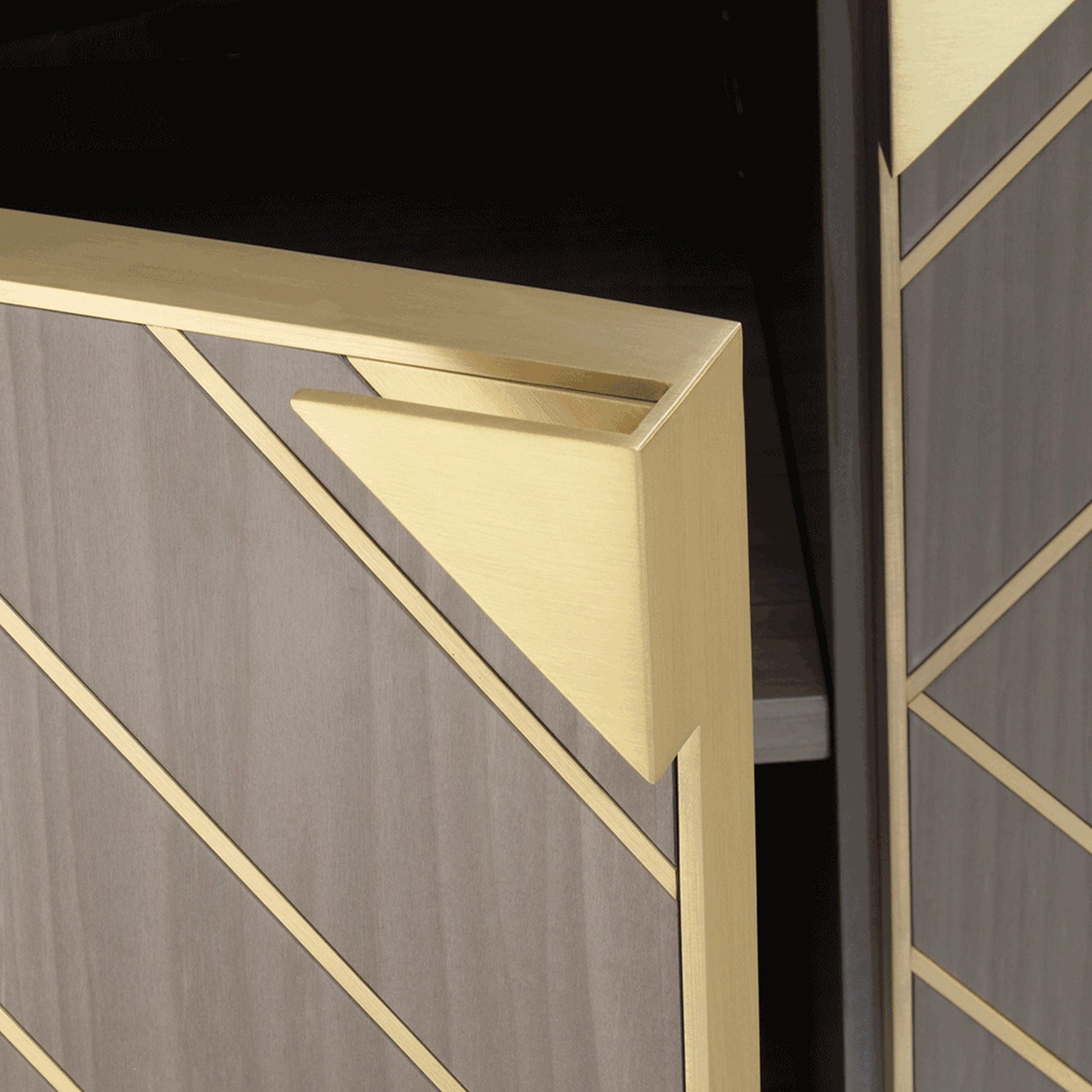 Close up of luxury four door sideboard with modern diagonal brass inlay and dark wood legs and brass details.