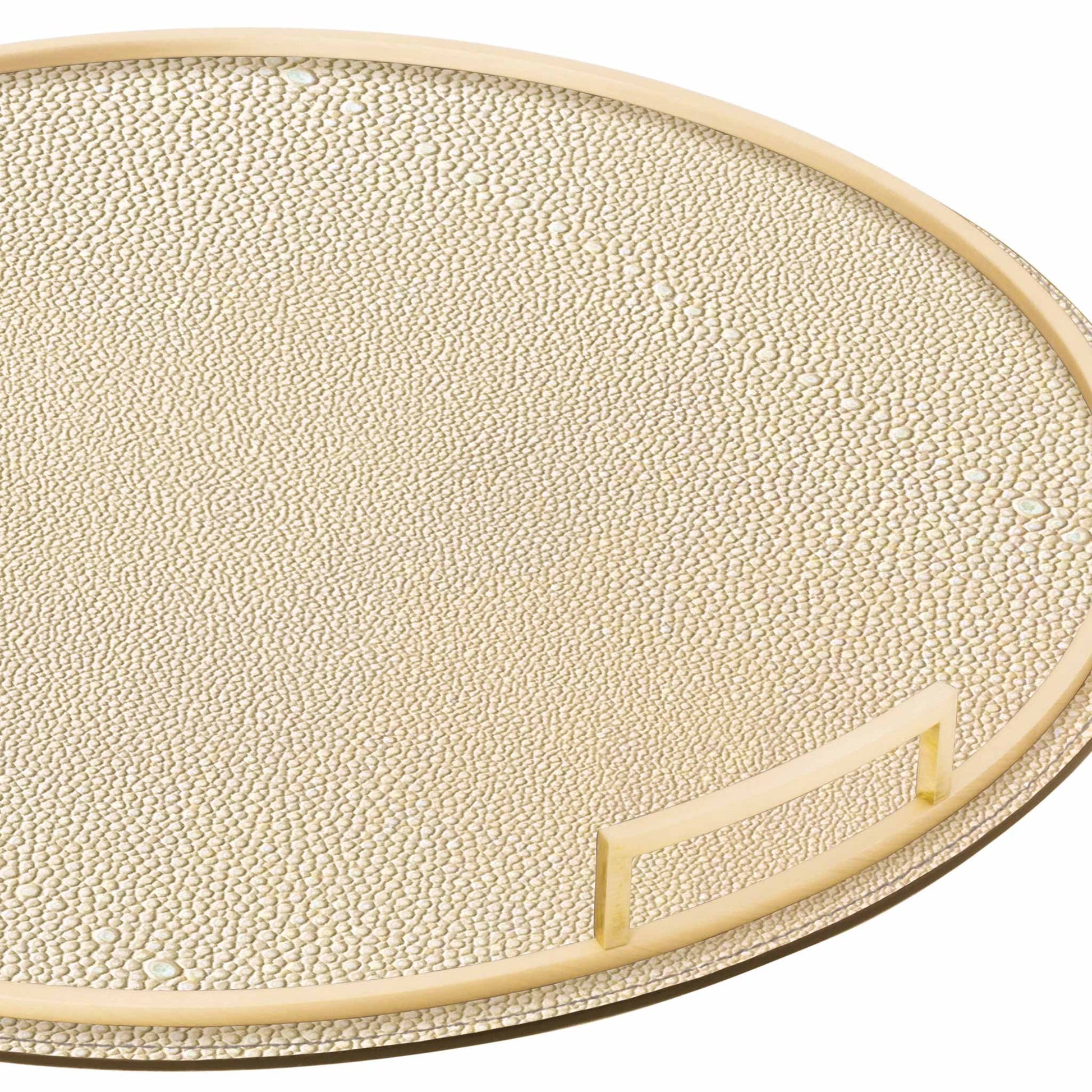 Close up of round cream shagreen textured Italian leather tray with brass handles