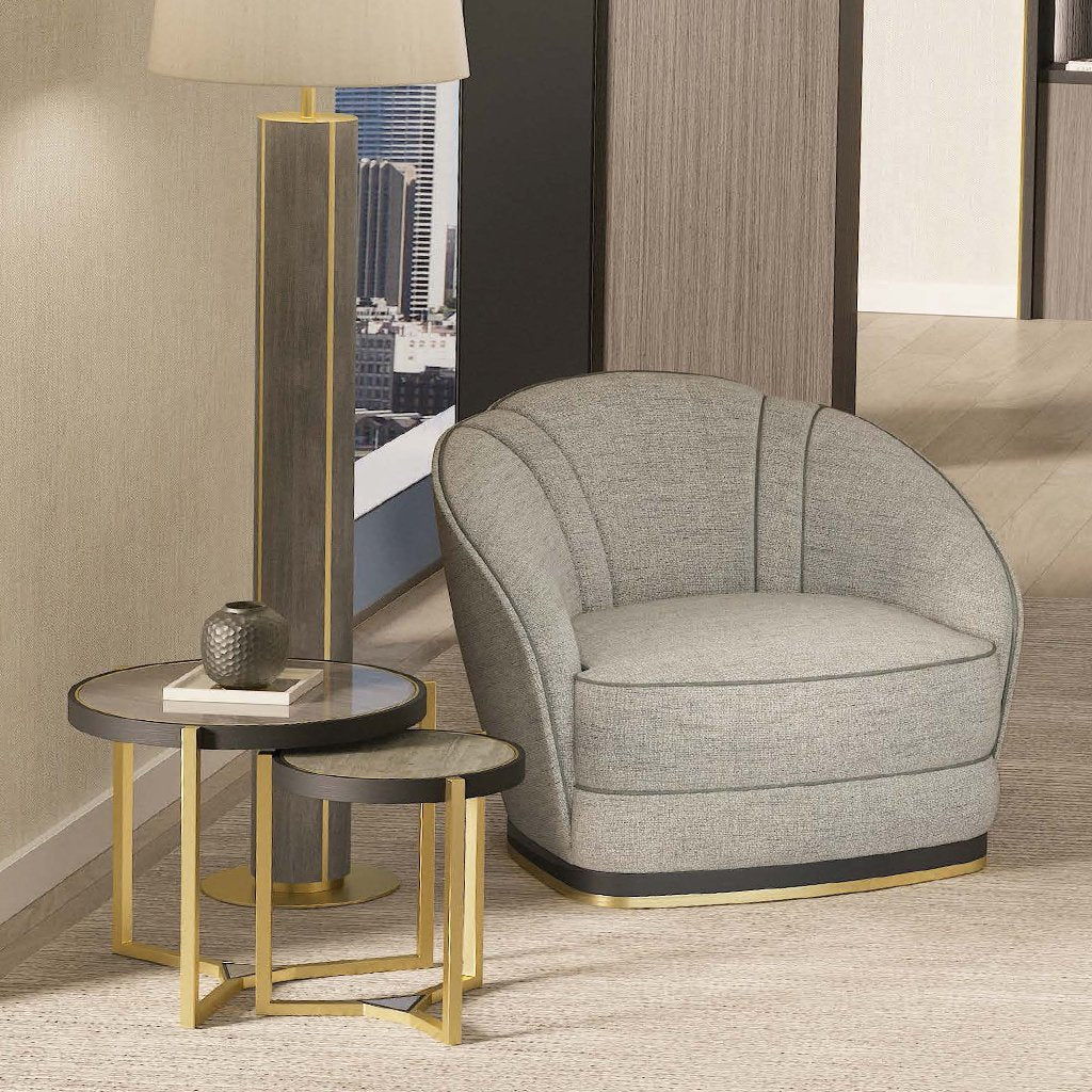 a lifestyle image showing the nesting table set within a home, next to an armchair and floor lamp