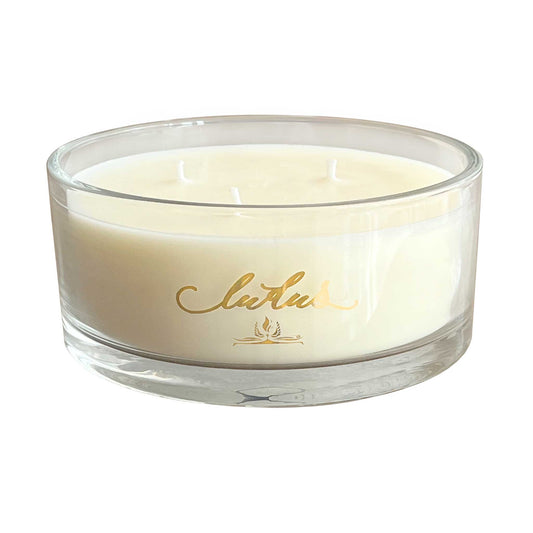 A three wick Wild FIg candle in a wide glass jar.