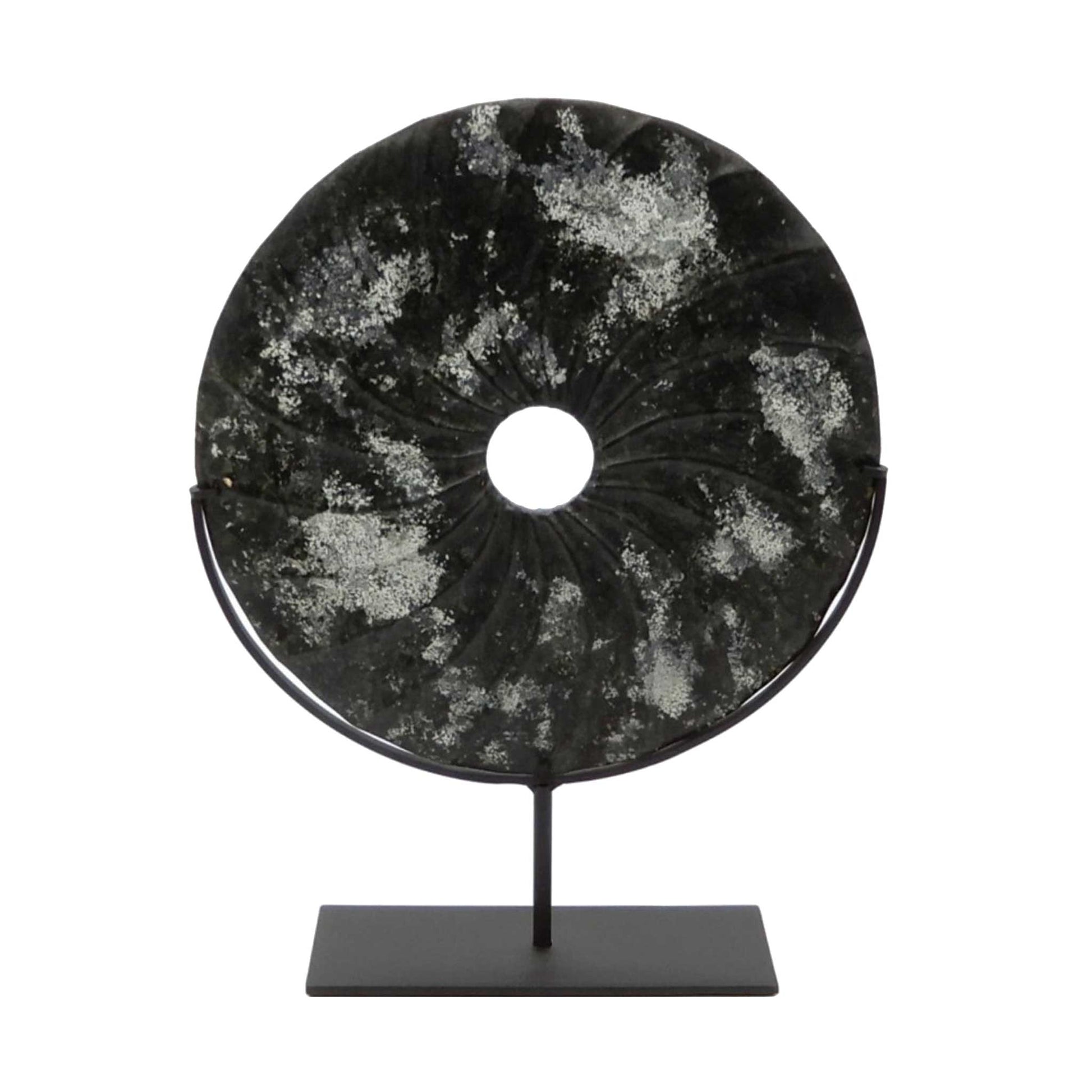 Distressed black marble bi disc with shell type grooves displayed on a bronze stand 