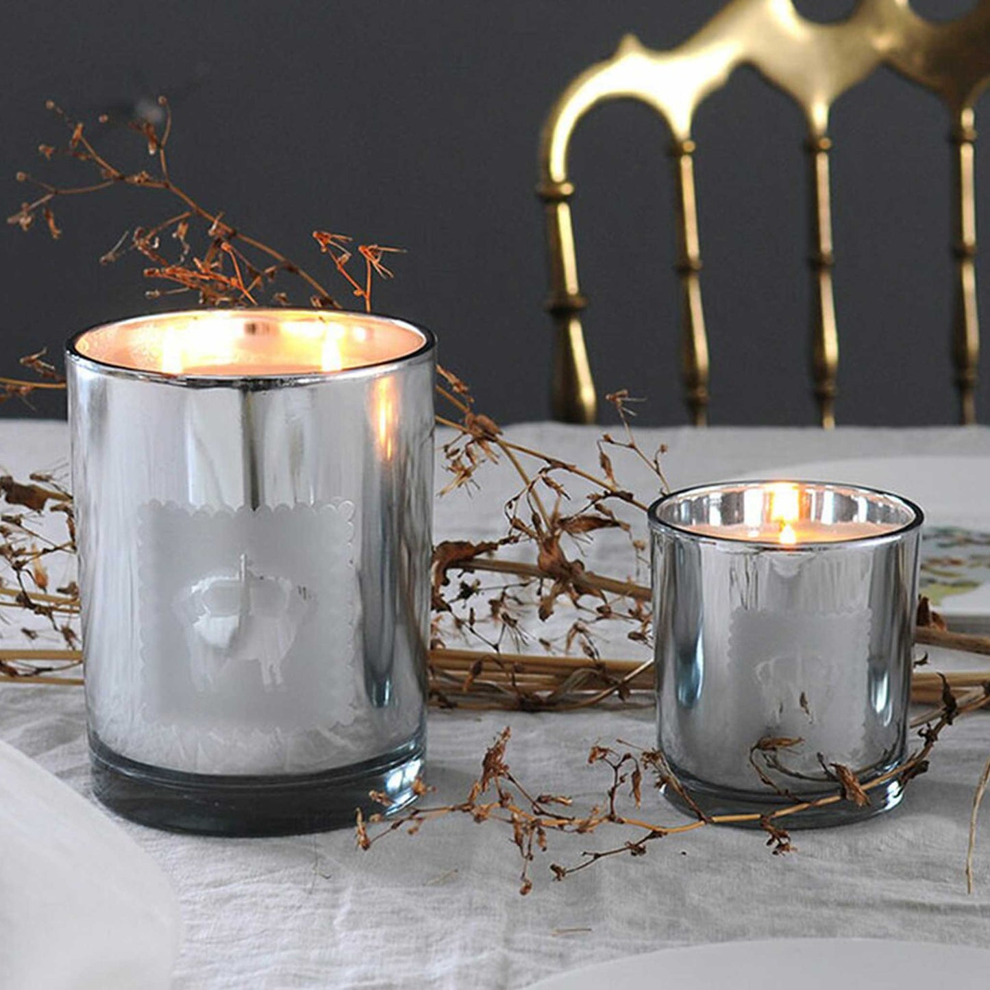 Lavender candle in modern silver metallic jar in two sizes shown on a dining room table decorated for a special event