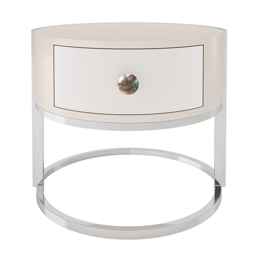 circular high gloss bedside table in a pale pink, with a leather finished drawer front and set of a polished stainless steel frame